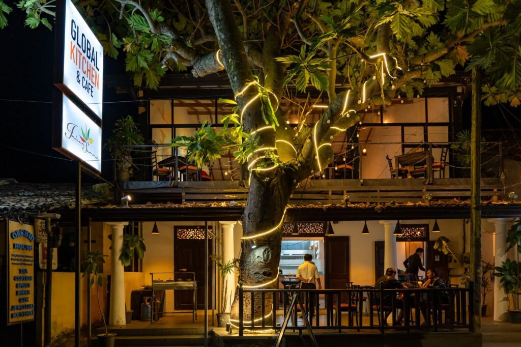 A cozy café in Galle, Sri Lanka, beautifully lit at night with outdoor seating.