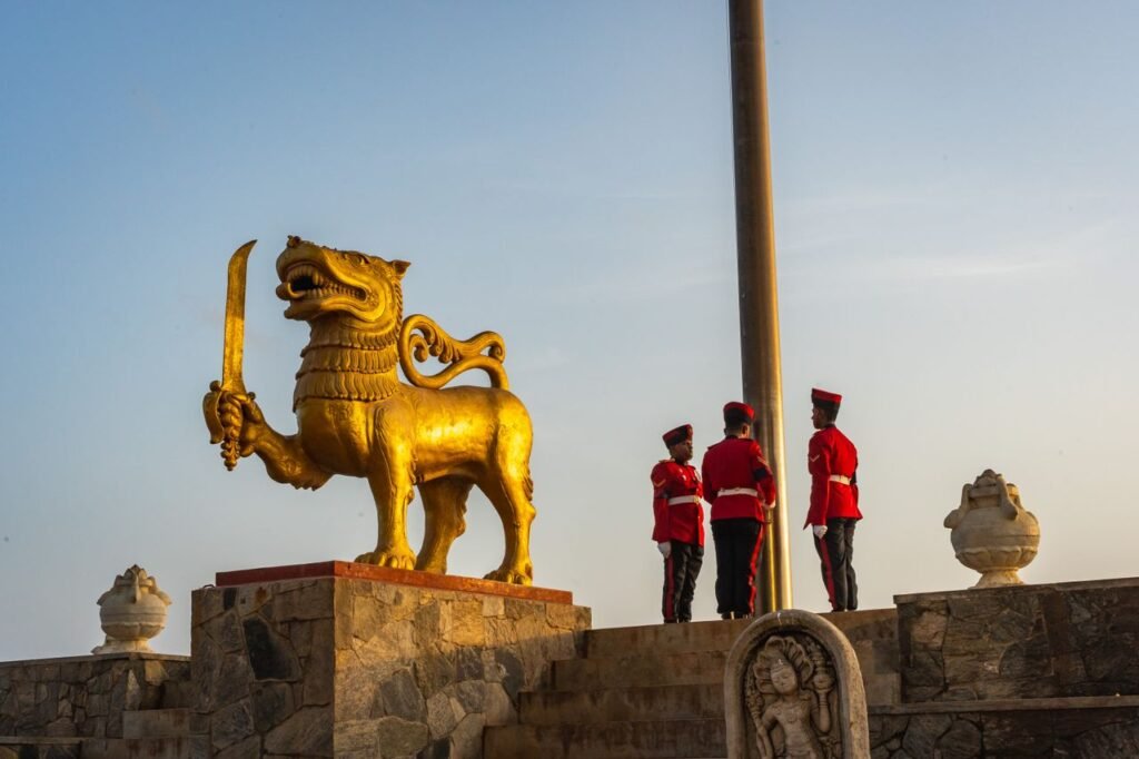 Golden lion statue and guards at Independence Memorial Square, Colombo, Sri Lanka.