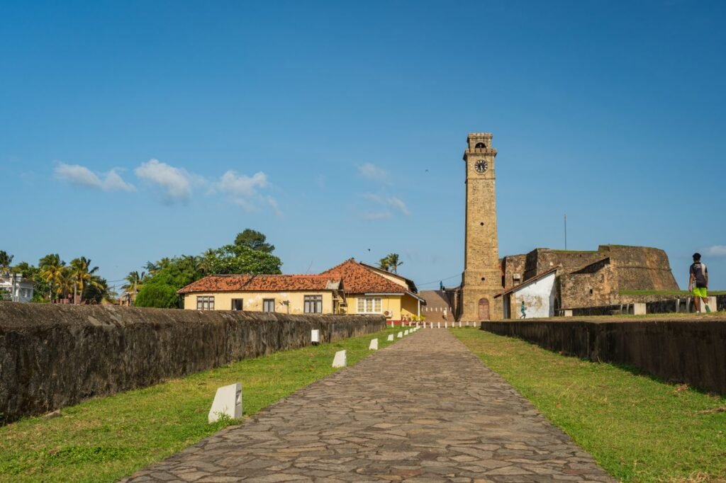 Explore the historic Galle Fort with its iconic clock tower under a clear, sunny sky.