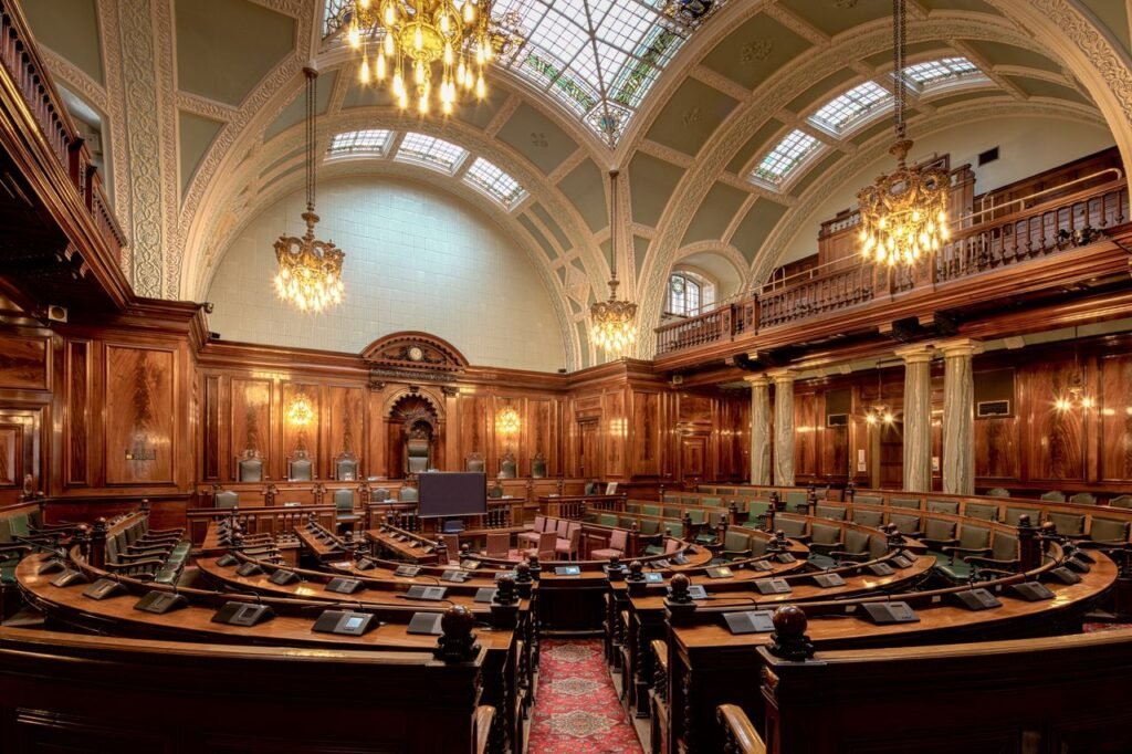 A beautifully designed chamber room with ornate woodwork and chandeliers in the UK.